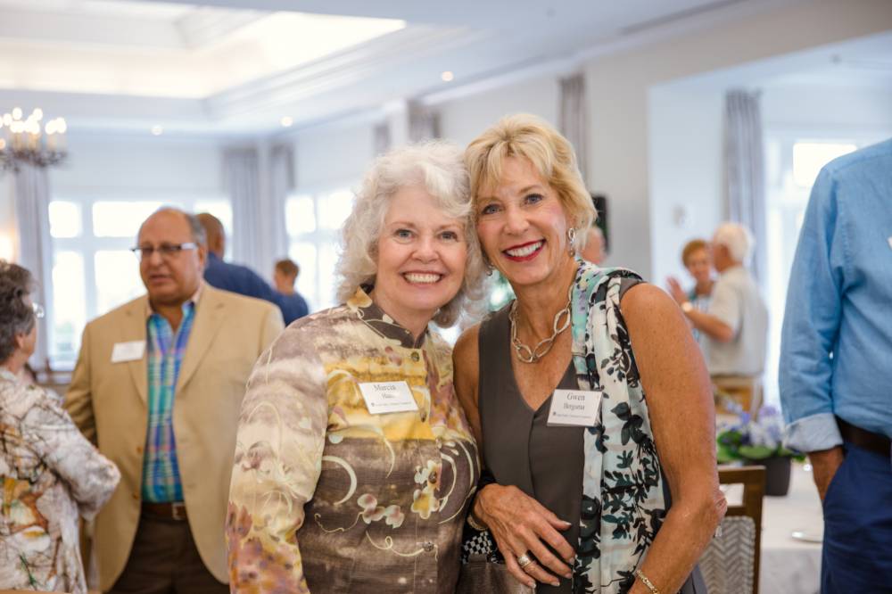 Marcia Haas smiling with guest at Naples 2019